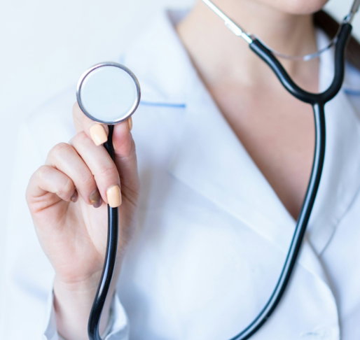 a-woman-in-a-white-shirt-holding-a-stethoscope.jpg a woman in a white shirt holding a stethoscope