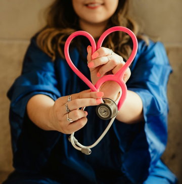 girl-in-blue-jacket-holding-red-and-silver-ring.jpg girl in blue jacket holding red and silver ring